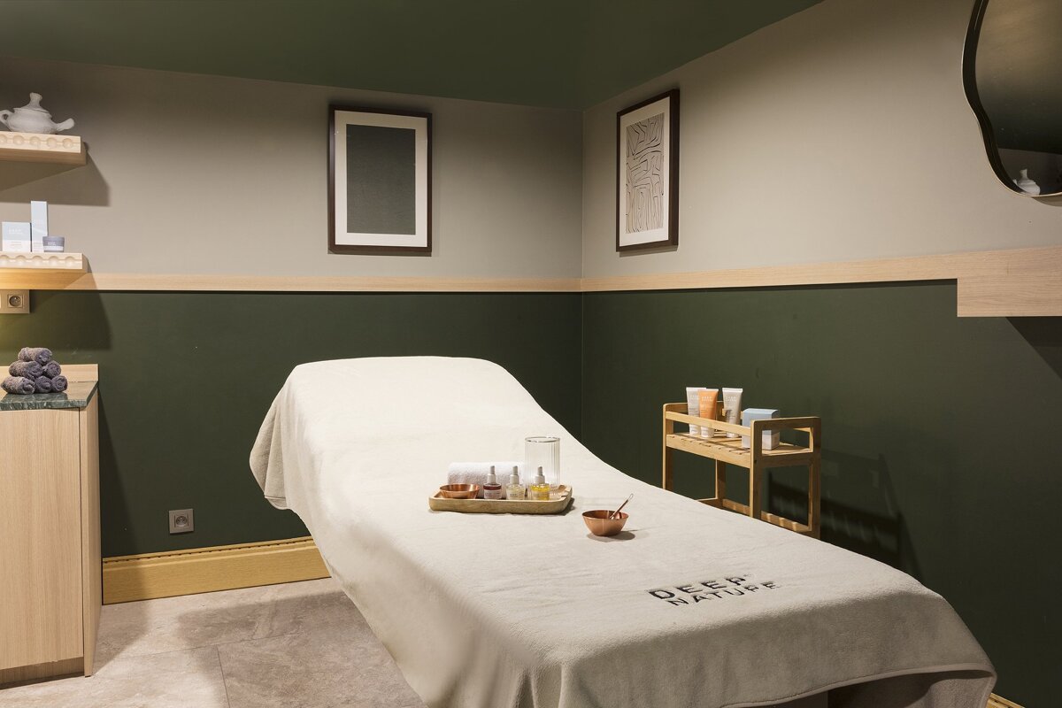 A massage table with a towel that says deep nature on it