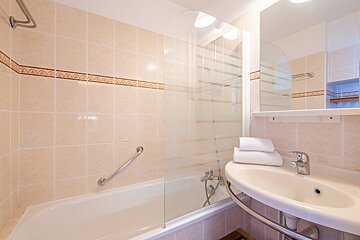 A bathroom with a bathtub and a sink