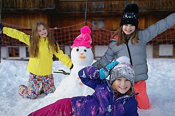 A girl wearing a jacket that says ' columbia ' on it