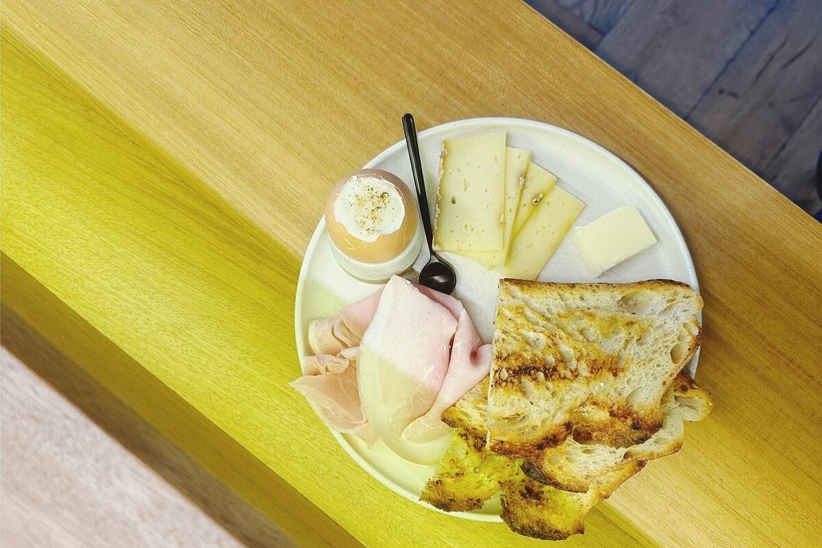 A plate of food on a table with a spoon