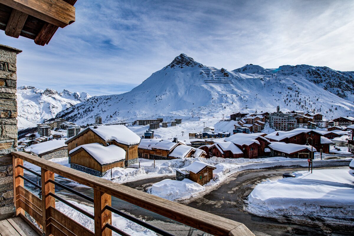 A snowy village with a mountain in the background