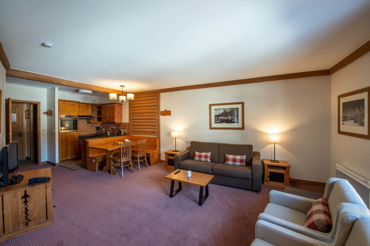 A living room with a couch and two chairs