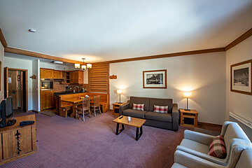 A living room with a couch and two chairs