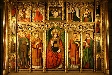 A painting of jesus surrounded by angels and saints has the word jesus on it