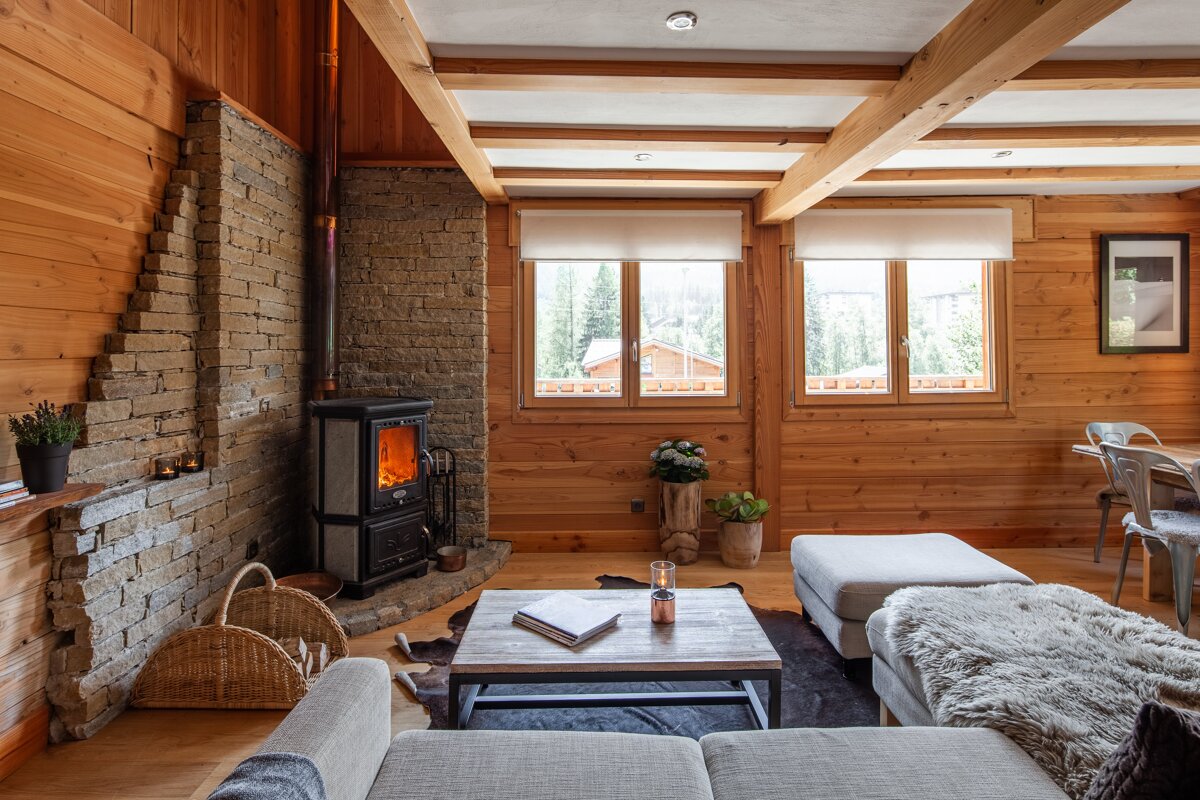 A living room with a wood stove and a couch