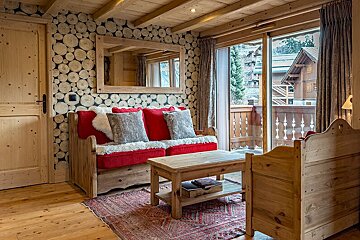 A living room with a couch and a table and a book called cata