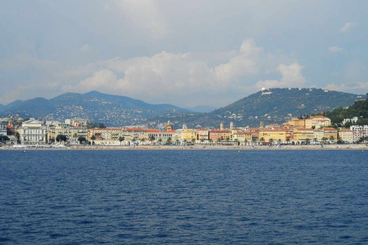 a long beach taken from a distance on a boat