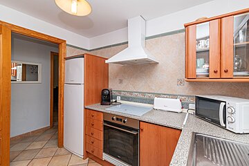A kitchen with a microwave and a toaster oven