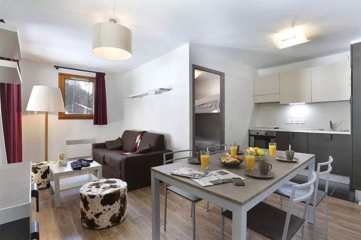 A living room with a table and chairs and a couch