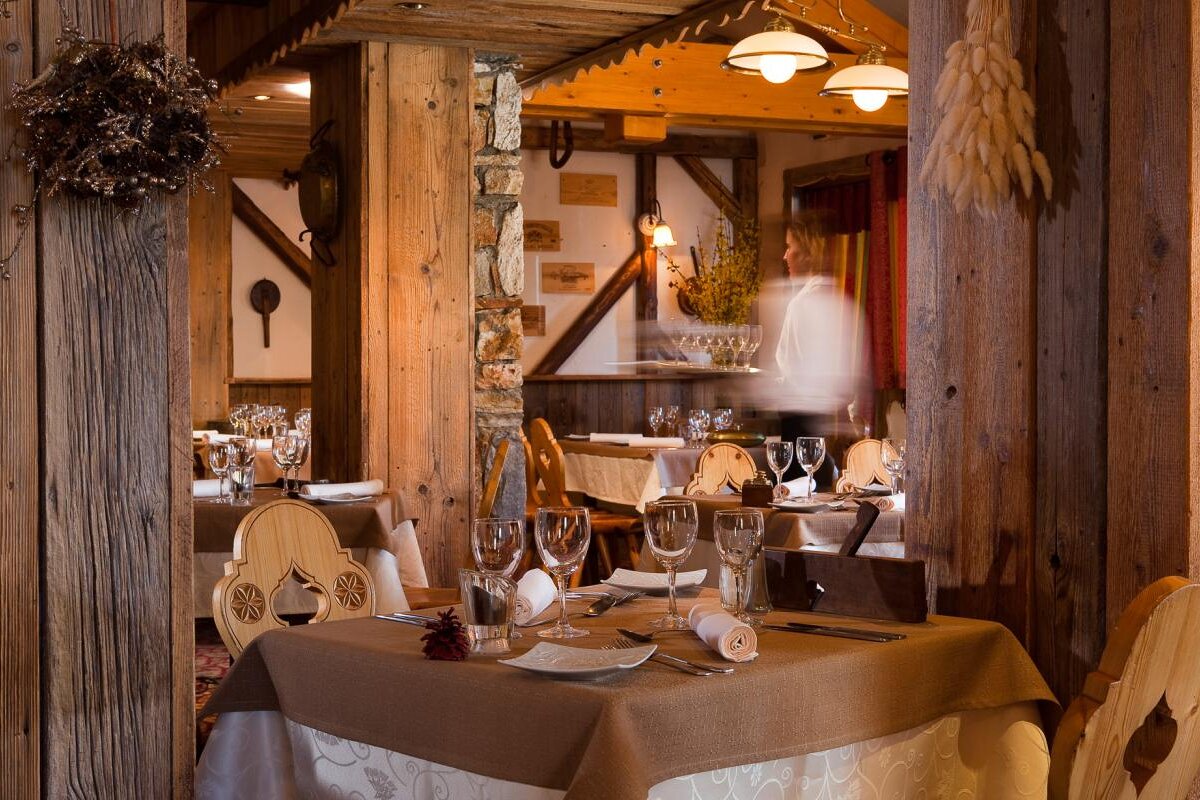 A blurred image of a restaurant with tables and chairs