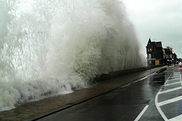 Wave crashiong over on to the road in st malo