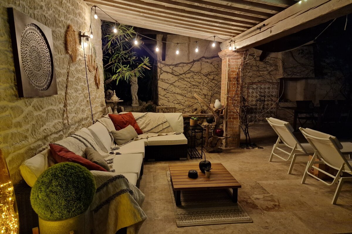 A patio area with a couch and a coffee table