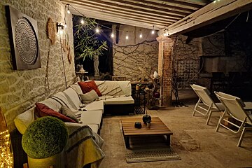 A patio area with a couch and a coffee table