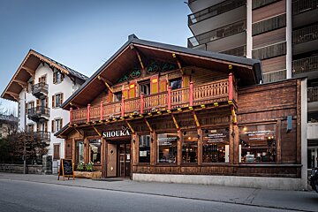 A wooden building with the word shouka on it