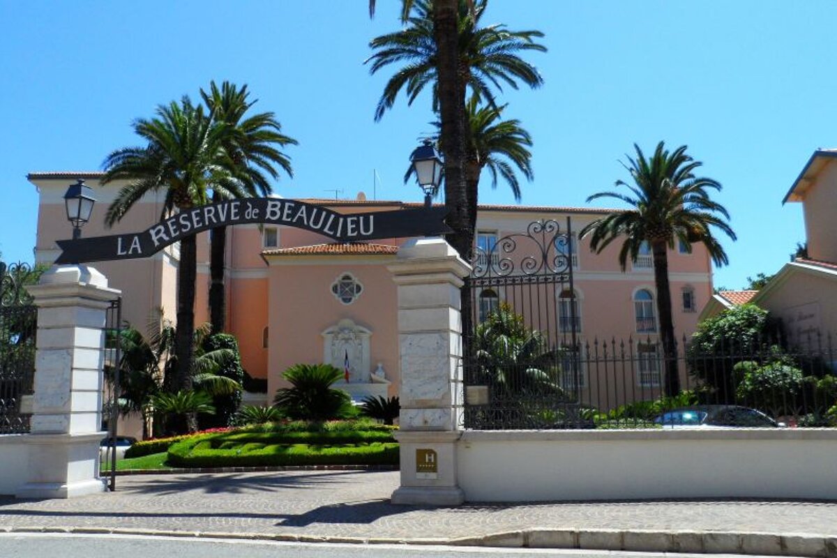 a peach coloured building with a sign outside