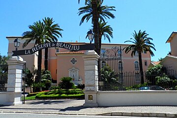a peach coloured building with a sign outside