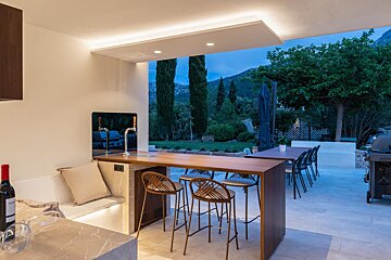A bottle of wine sits on a counter in a kitchen