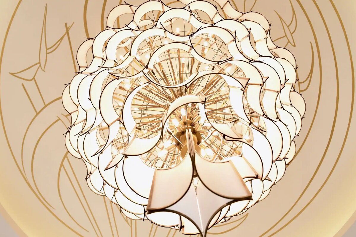 A chandelier that looks like a flower is hanging from the ceiling