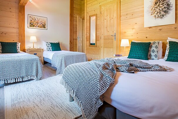 a room with multiple beds for families