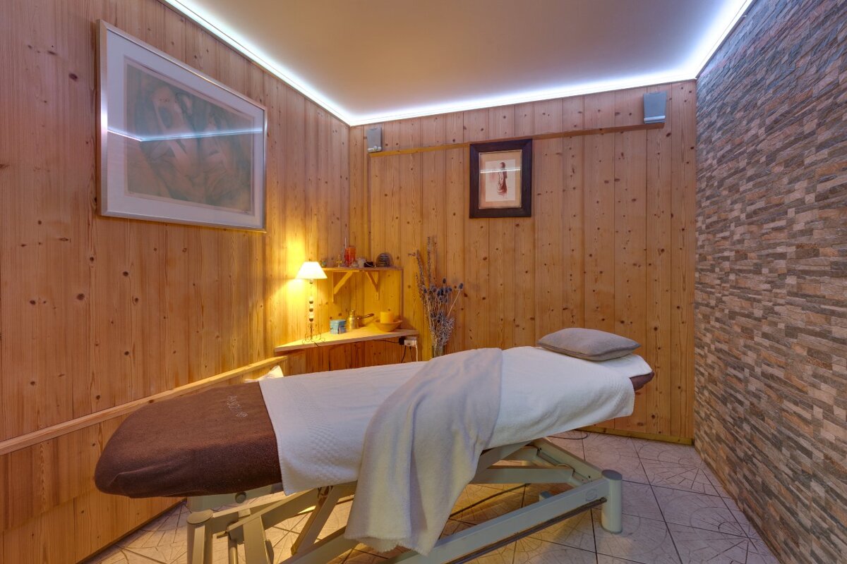 A massage table in a room with wooden walls