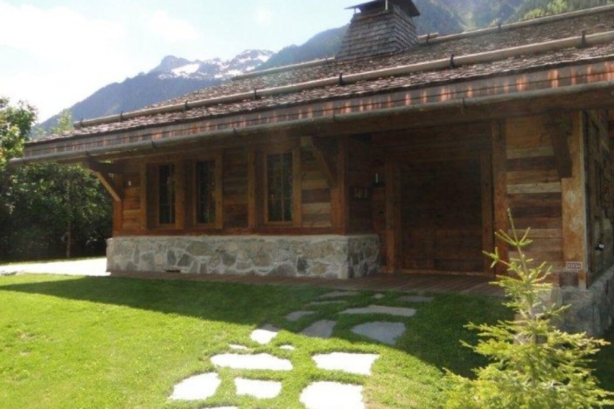 A wooden house with a roof that has shingles on it