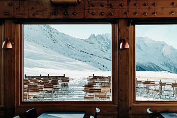 A view of a snowy mountain from a restaurant window