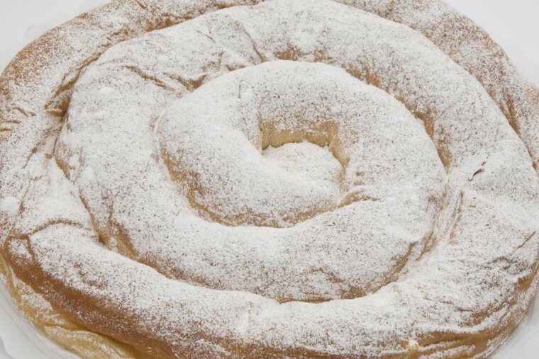 A pastry with powdered sugar on top of it