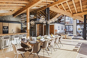 A dining room table with plates and glasses on it