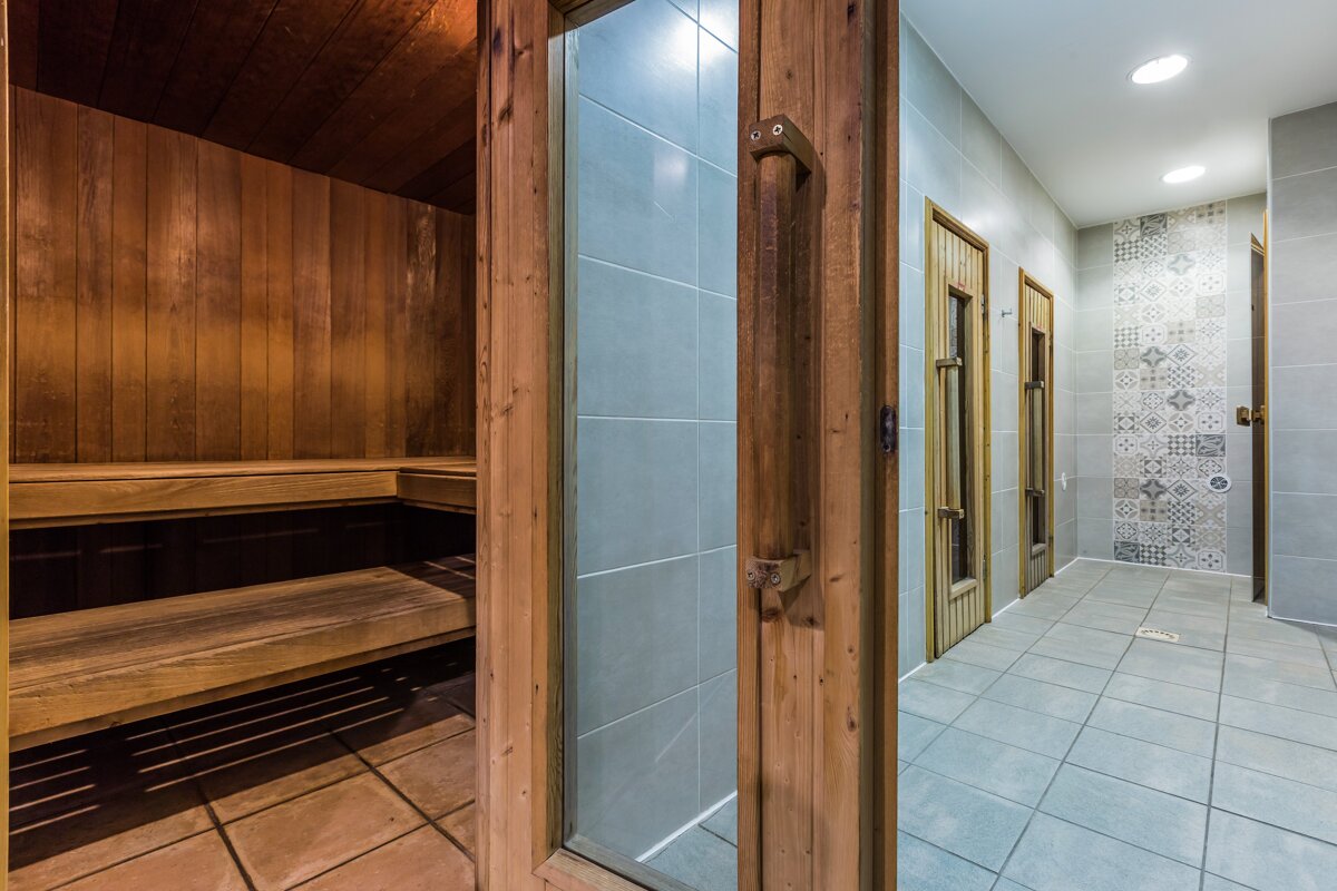 A wooden sauna with a glass door