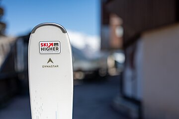 A white Dynastar ski with a 