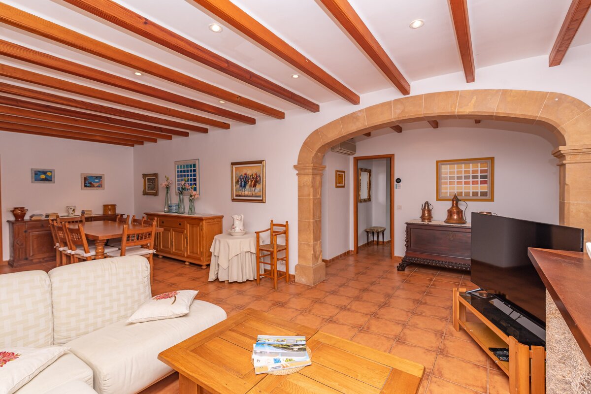 A living room with a couch a table and a television