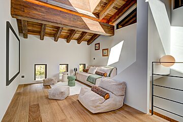 A living room with wooden beams and a couch