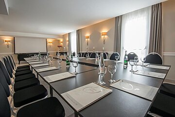 A conference room set up with a long table and chairs