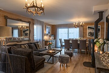 A living room with a couch a table and chairs