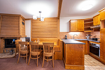 A kitchen with wooden cabinets and a fireplace