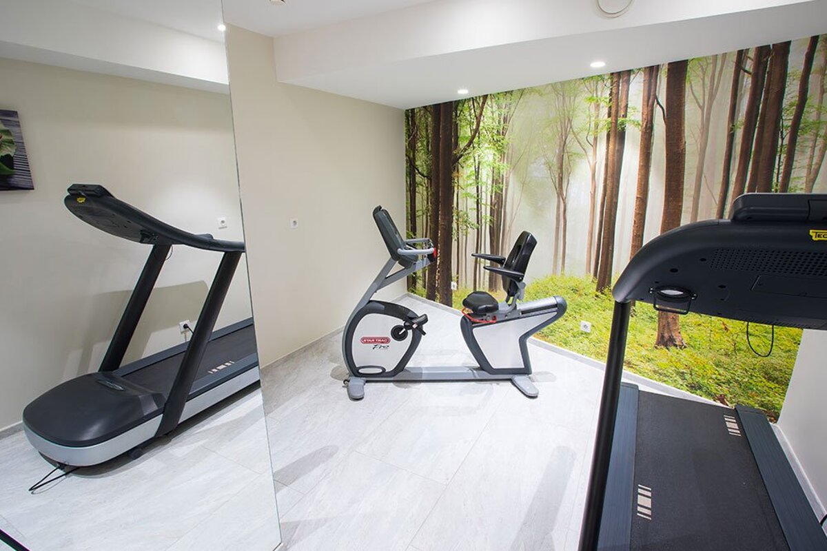 A treadmill and a bike are in a gym