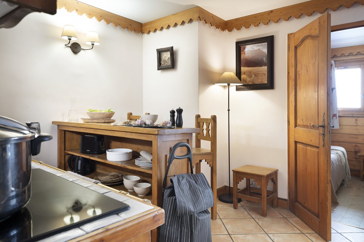 A kitchen with a pot on the stove and a picture on the wall