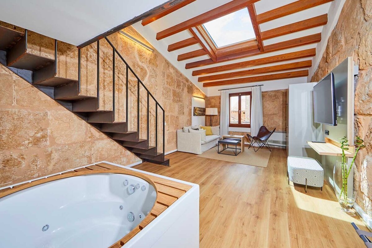 A living room with a staircase leading up to the second floor