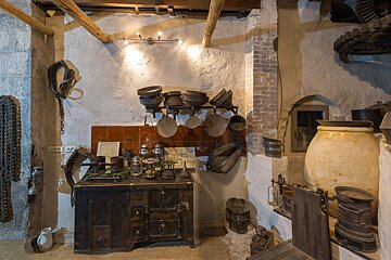 A kitchen with a lot of pots and pans on the wall