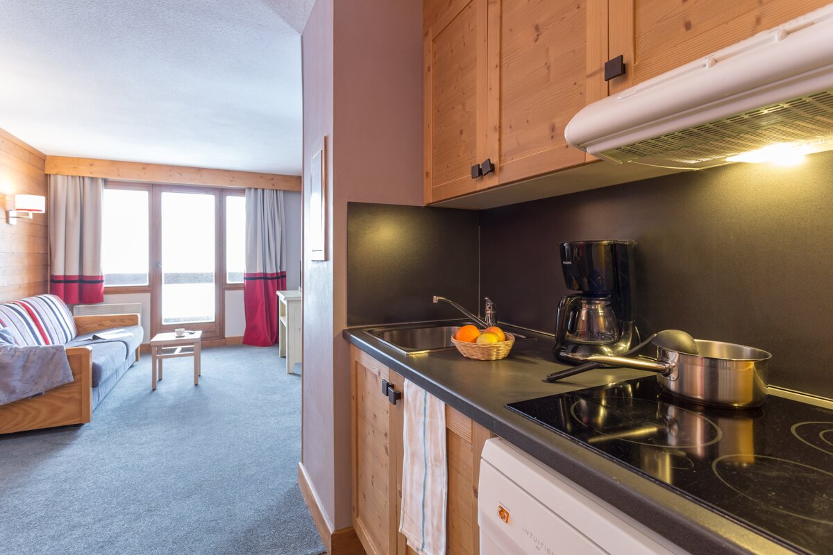 A kitchen with a stove top oven and a coffee maker