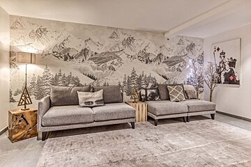 A living room with a couch and a painting on the wall