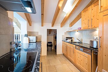 A kitchen with a british flag on the wall