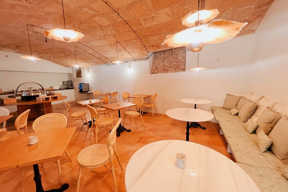 A dining room with tables and chairs and a couch