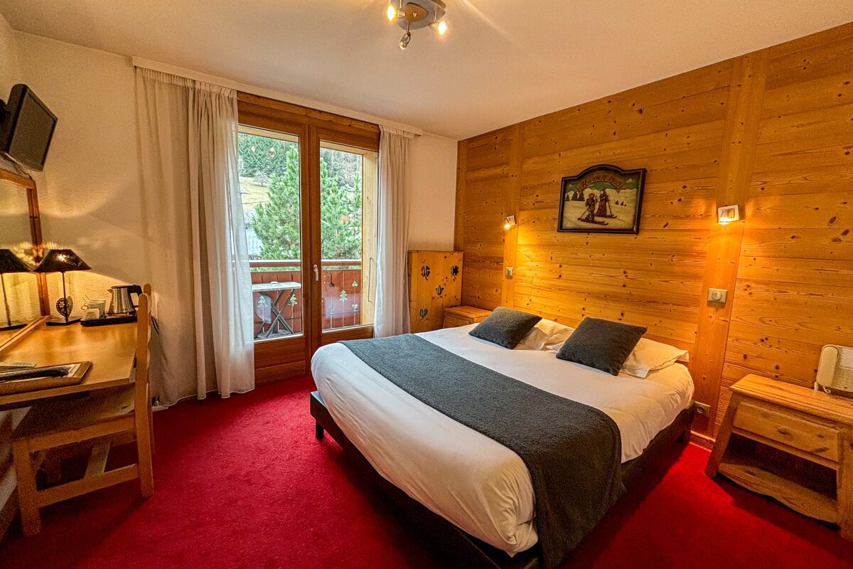 A hotel room with a large bed and a picture on the wall