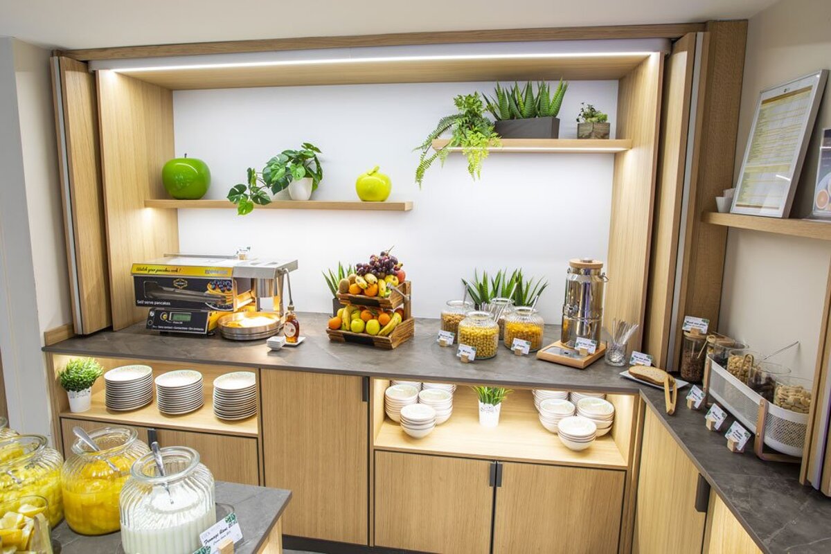 A buffet area with a display of food and a machine that says ' ice cream maker ' on it