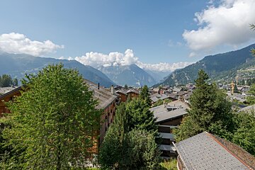 A view of a small town with mountains in the background