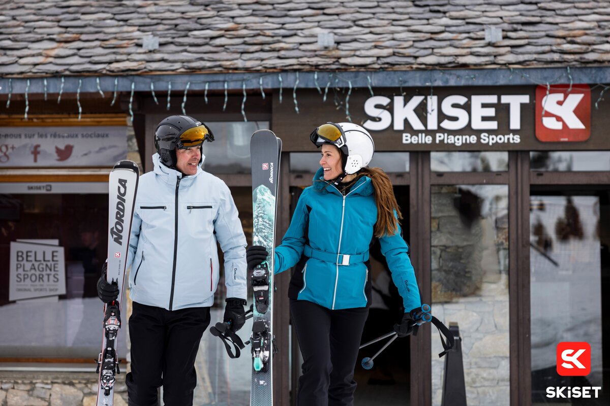 Two people standing in front of a ski set store