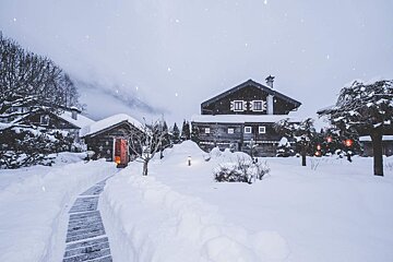 A snowy landscape with a telephone booth in the foreground