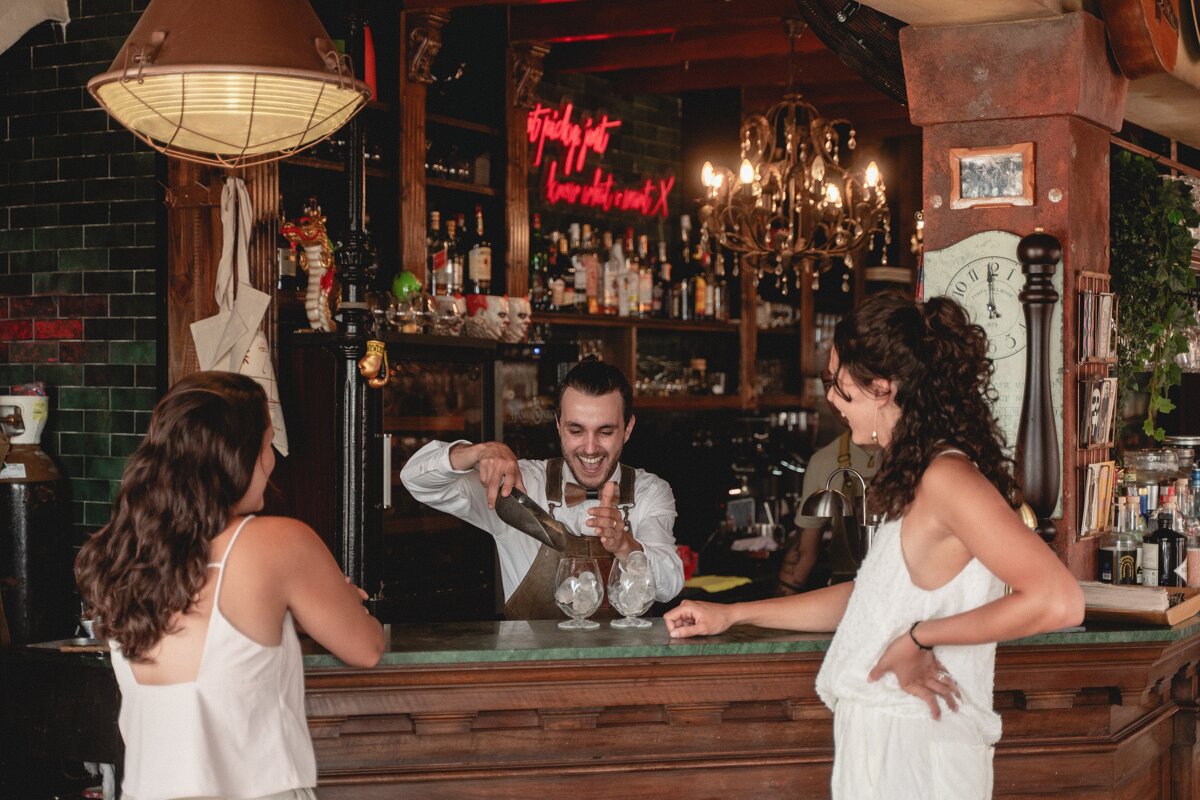 A bar with a neon sign that says simply put