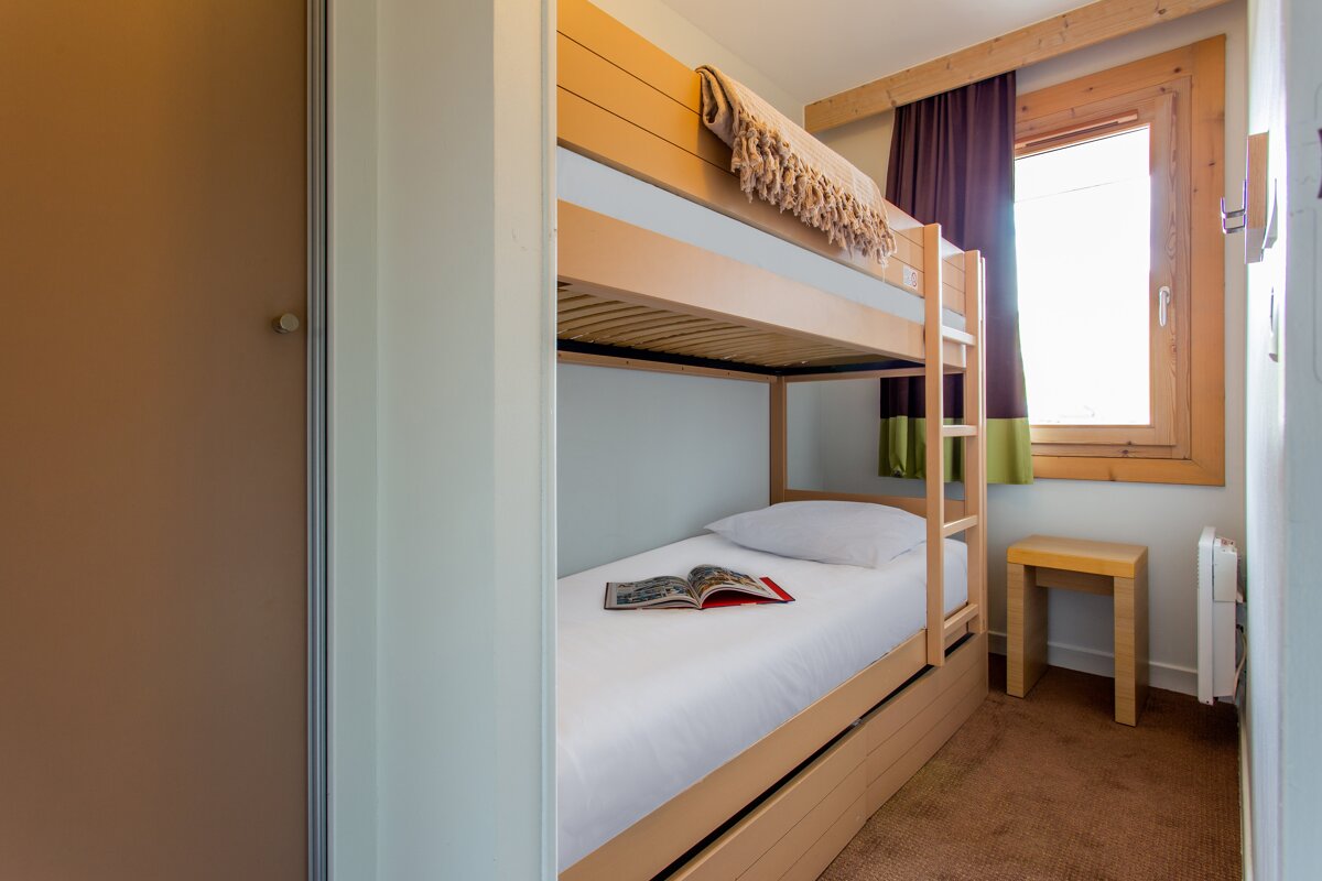 A bunk bed with a book on top of it